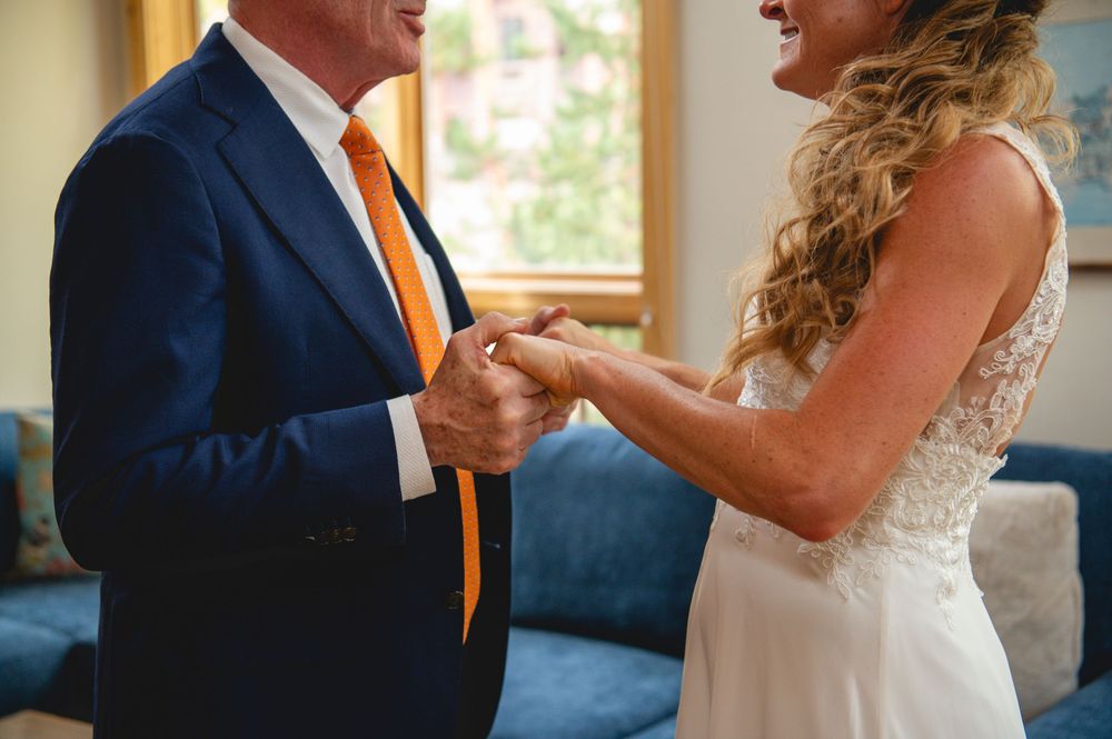 A couple shares a joyful moment as they dance together during their wedding celebration.