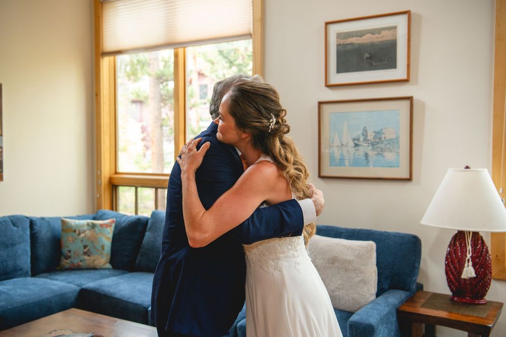 A series of four candid embracing moments shown on a couch in a living room with framed artwork on walls.