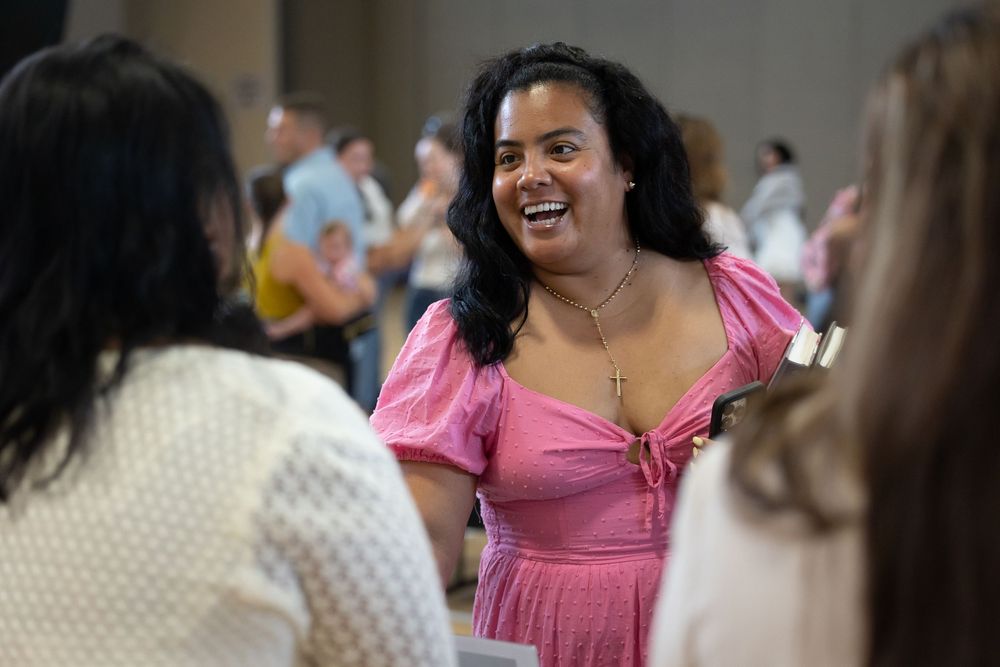 three ladies talking and laughing together