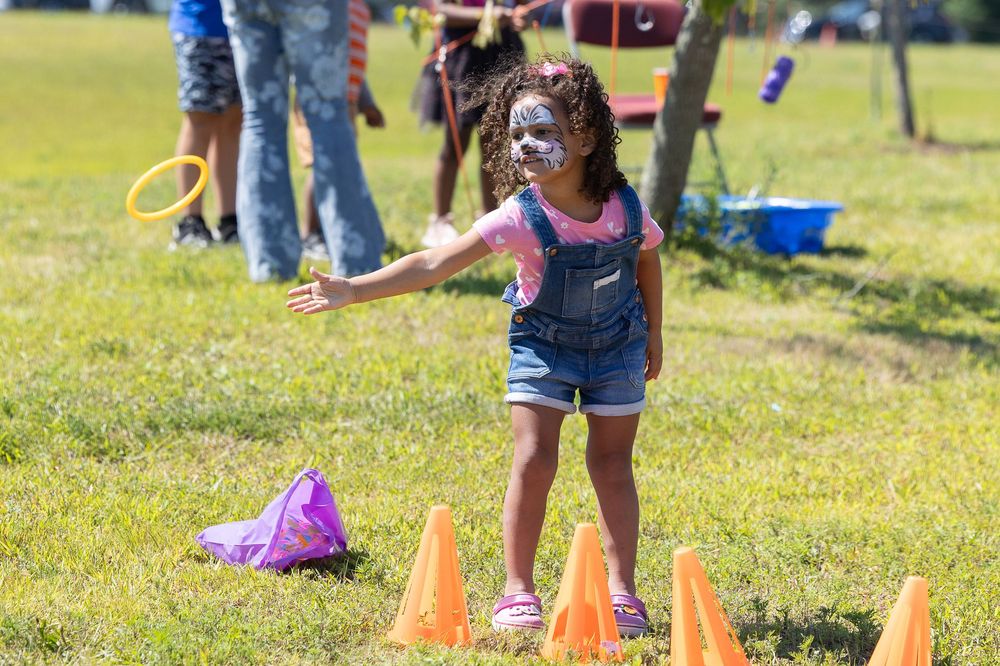 young child playing a game at a festival