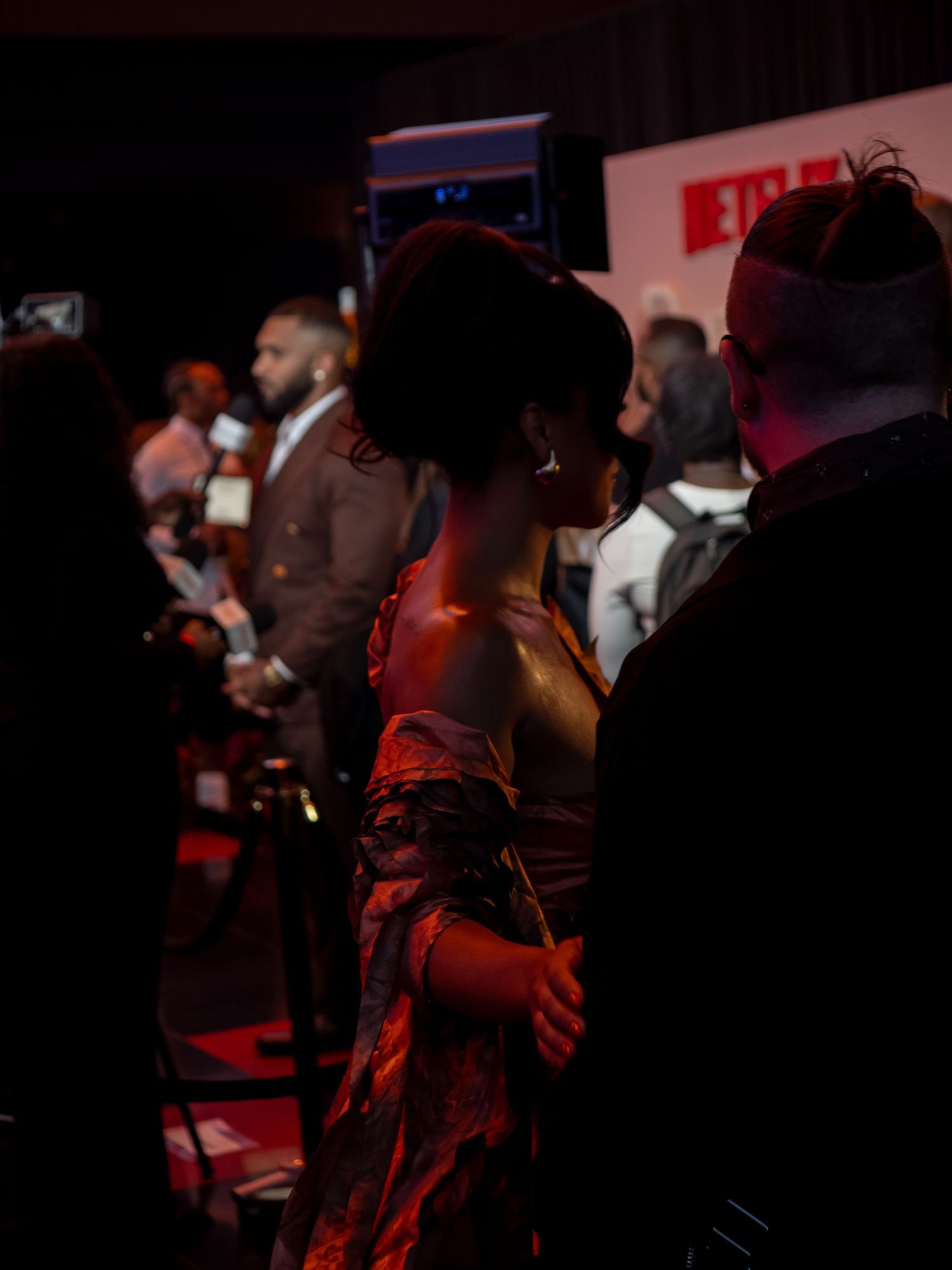 Dimly lit crowd gathers at an entertainment industry event with Netflix branding.