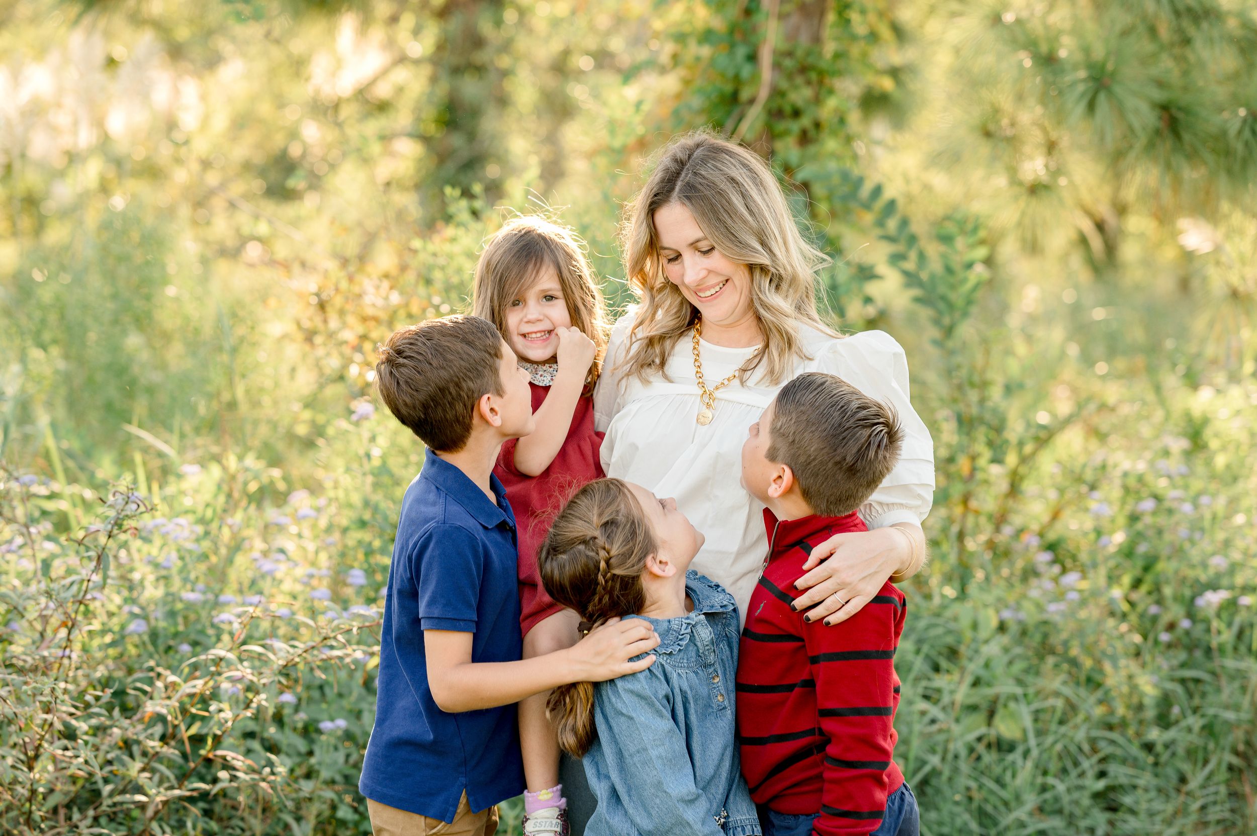 Children laughing in golden hour light at Houston fall mini photography session