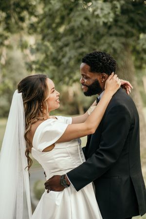 Series of candid moments showing a couple embracing during their wedding ceremony outdoors.