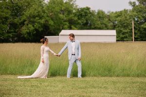 Golden hour wedding photos in a rustic outdoor field with couple in formal attire.