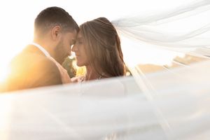 Romantic backlit wedding photos during golden hour with flowing veil. Hitching Post Ranch- Columbus, OH Wedding.