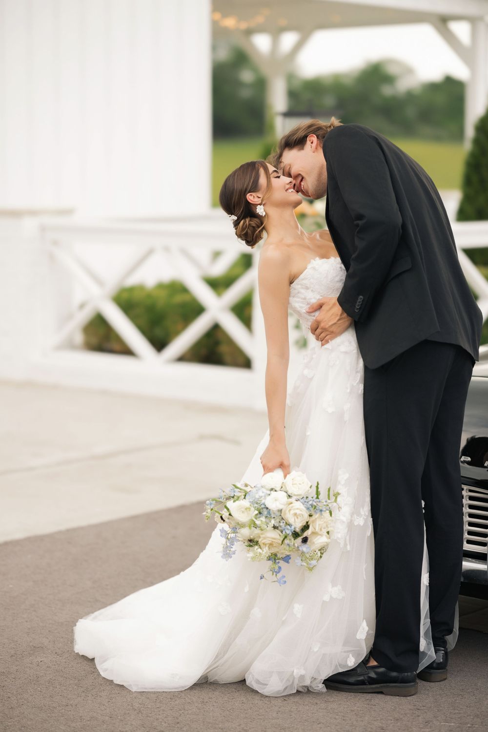 A romantic wedding photo sequence shows a couple in formal attire sharing an intimate dip pose on a paved walkway. Columbus, OH Wedding.