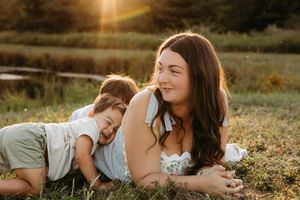 Sun-drenched outdoor portrait session capturing intimate moments in a natural setting at golden hour.
