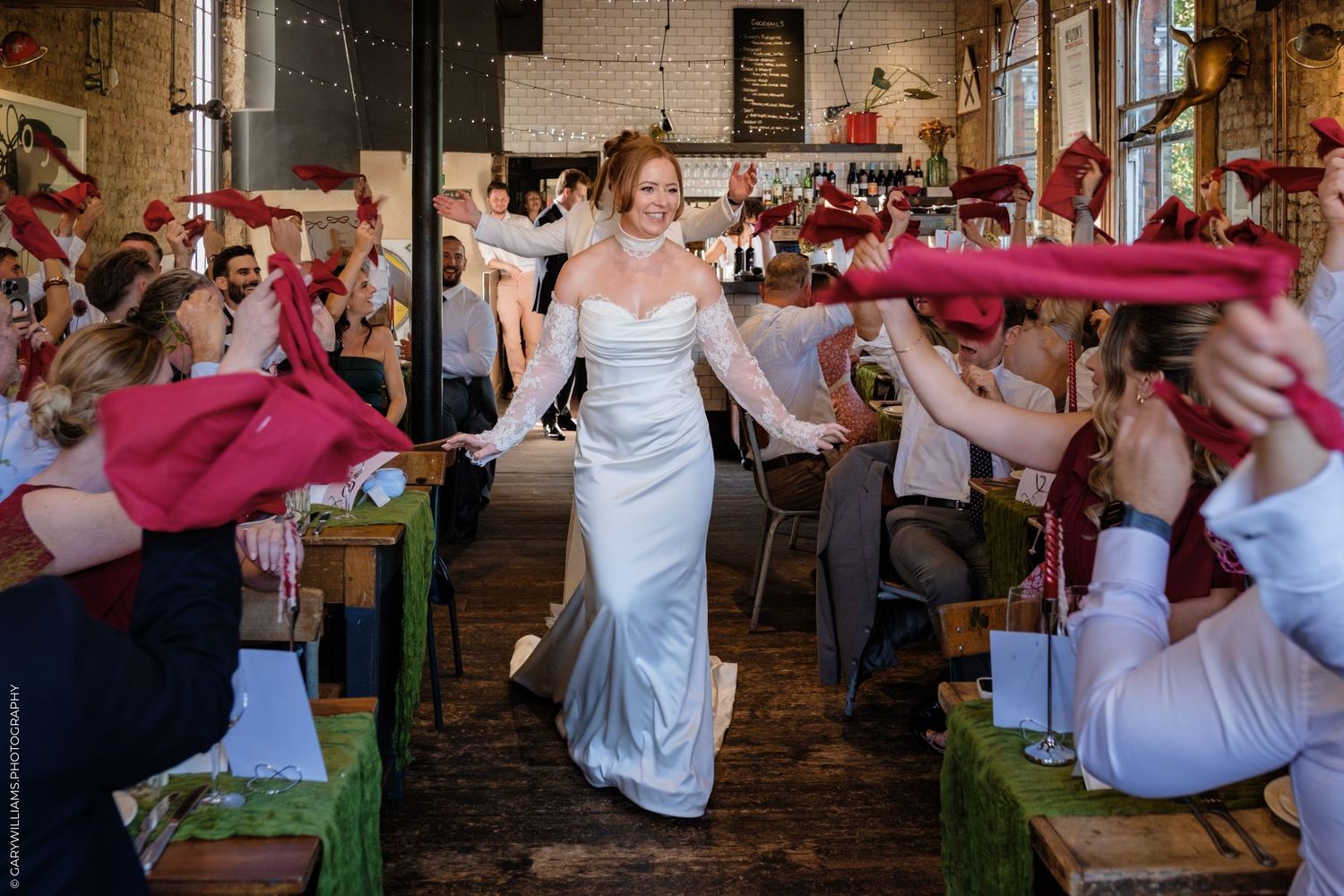 Woman in white dress twirls and dances energetically in sequence of candid movement shots at event.