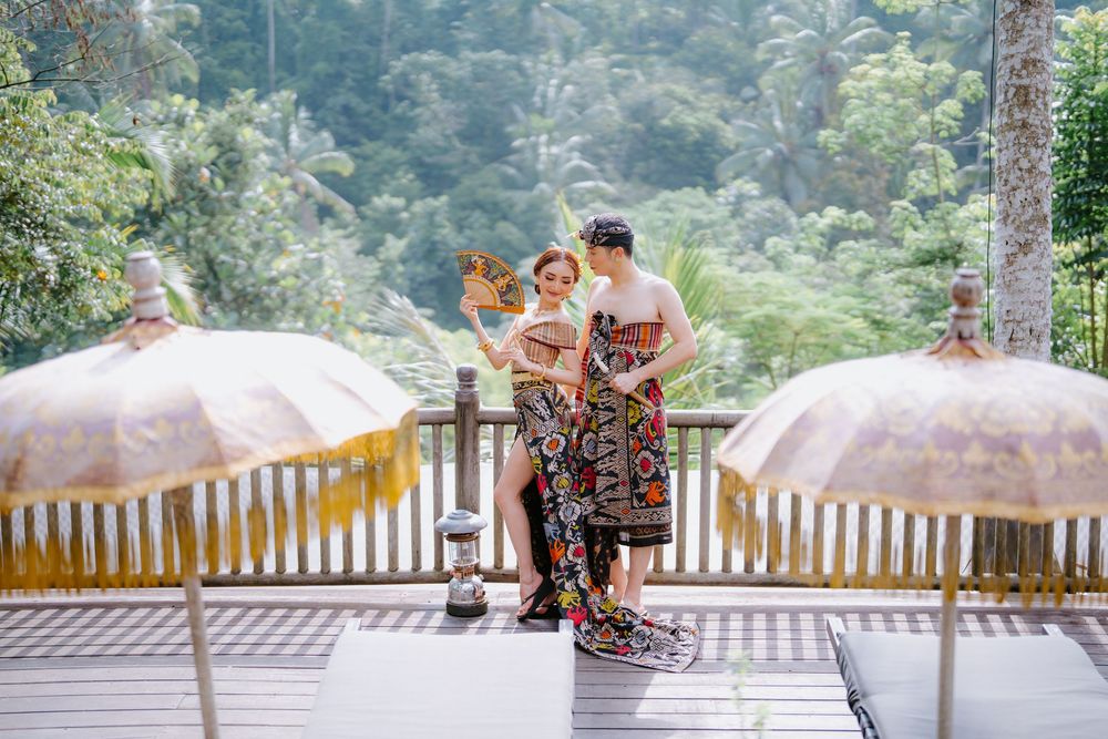 Romantic outdoor photography session on a mountain viewing deck surrounded by misty forest.