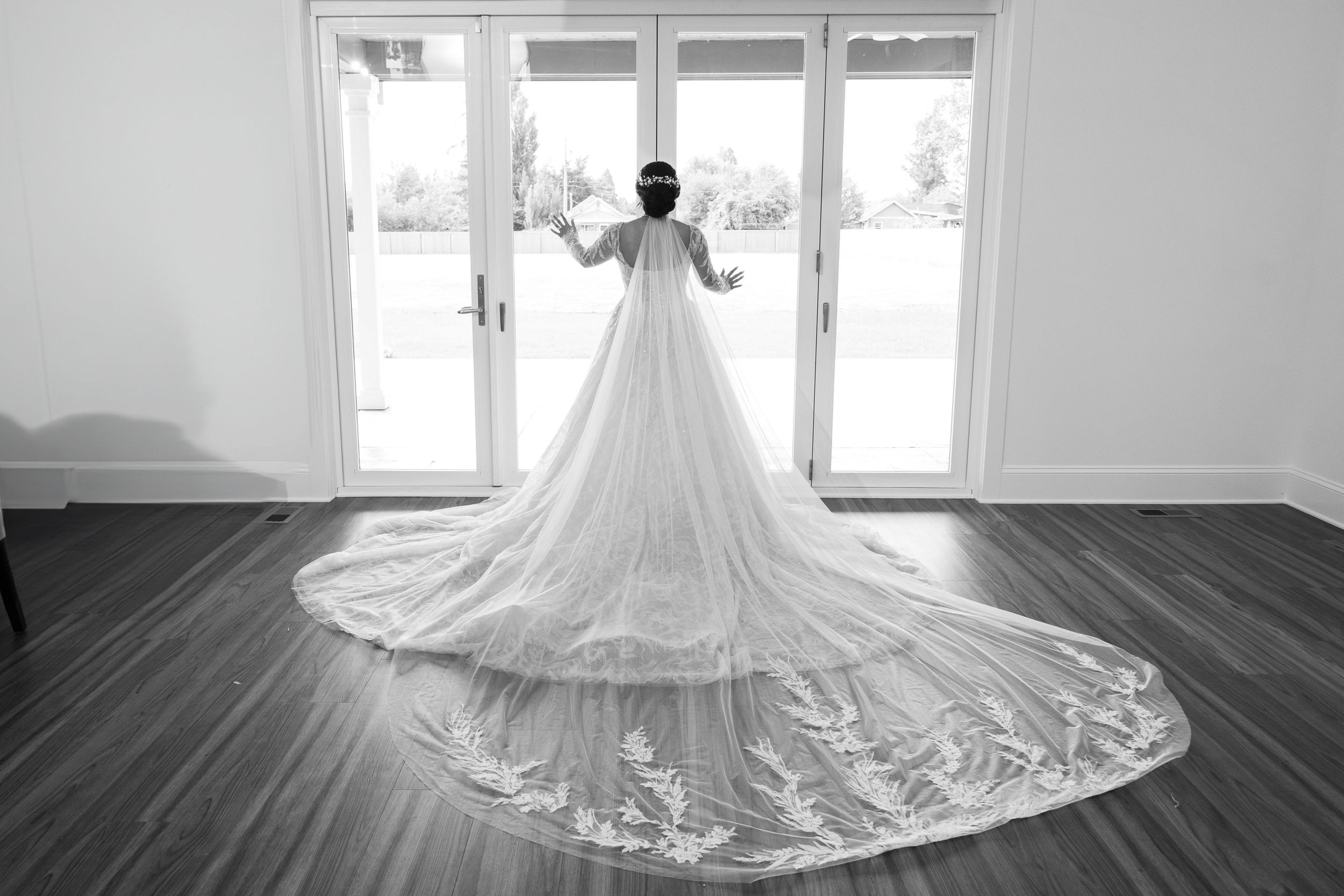 Elegant white wedding dress with lace details and long train displayed in multiple window-lit shots.