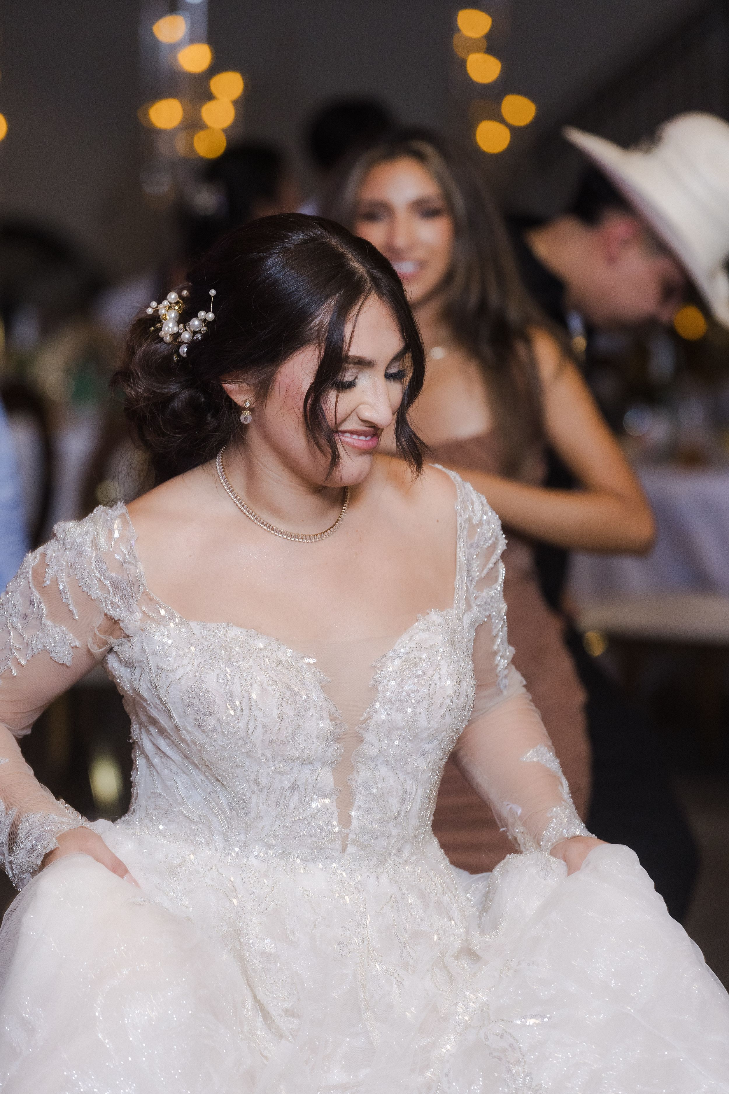A bride twirls in her lace wedding gown on the dance floor.
