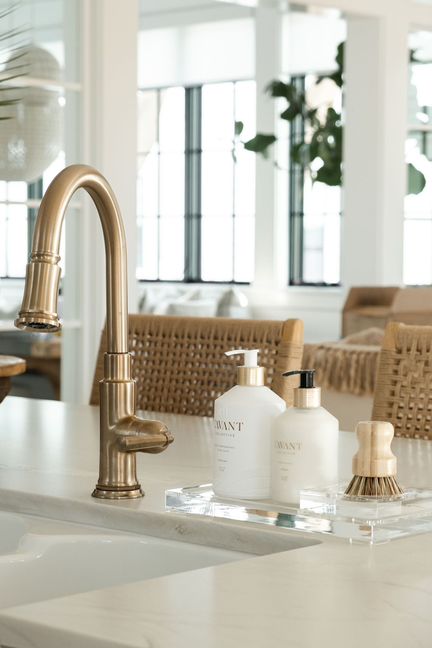 Luxury bathroom vanity with brass faucets and white soap dispensers.