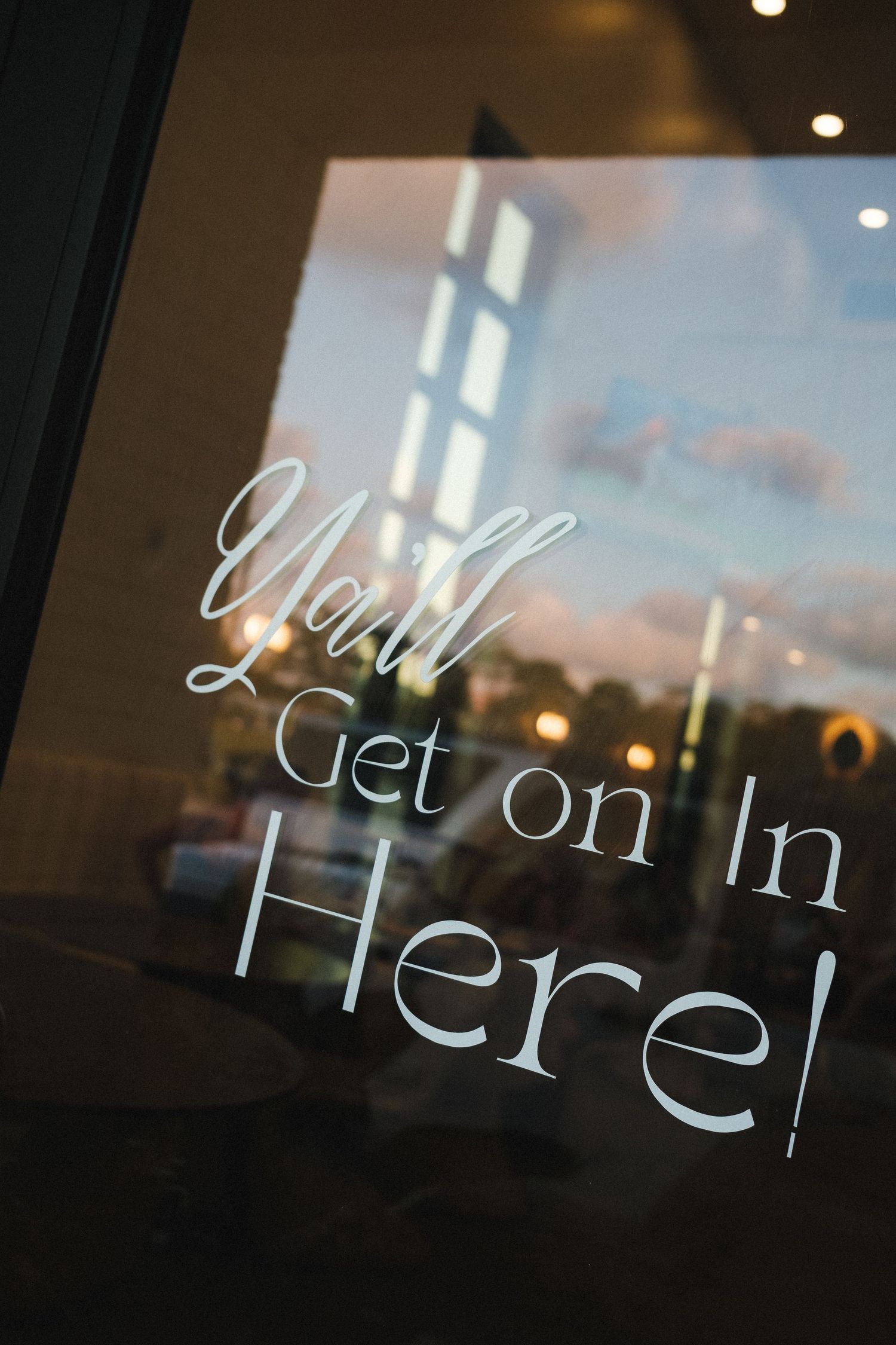 Close-up of frosted text on glass window creating an artistic effect.