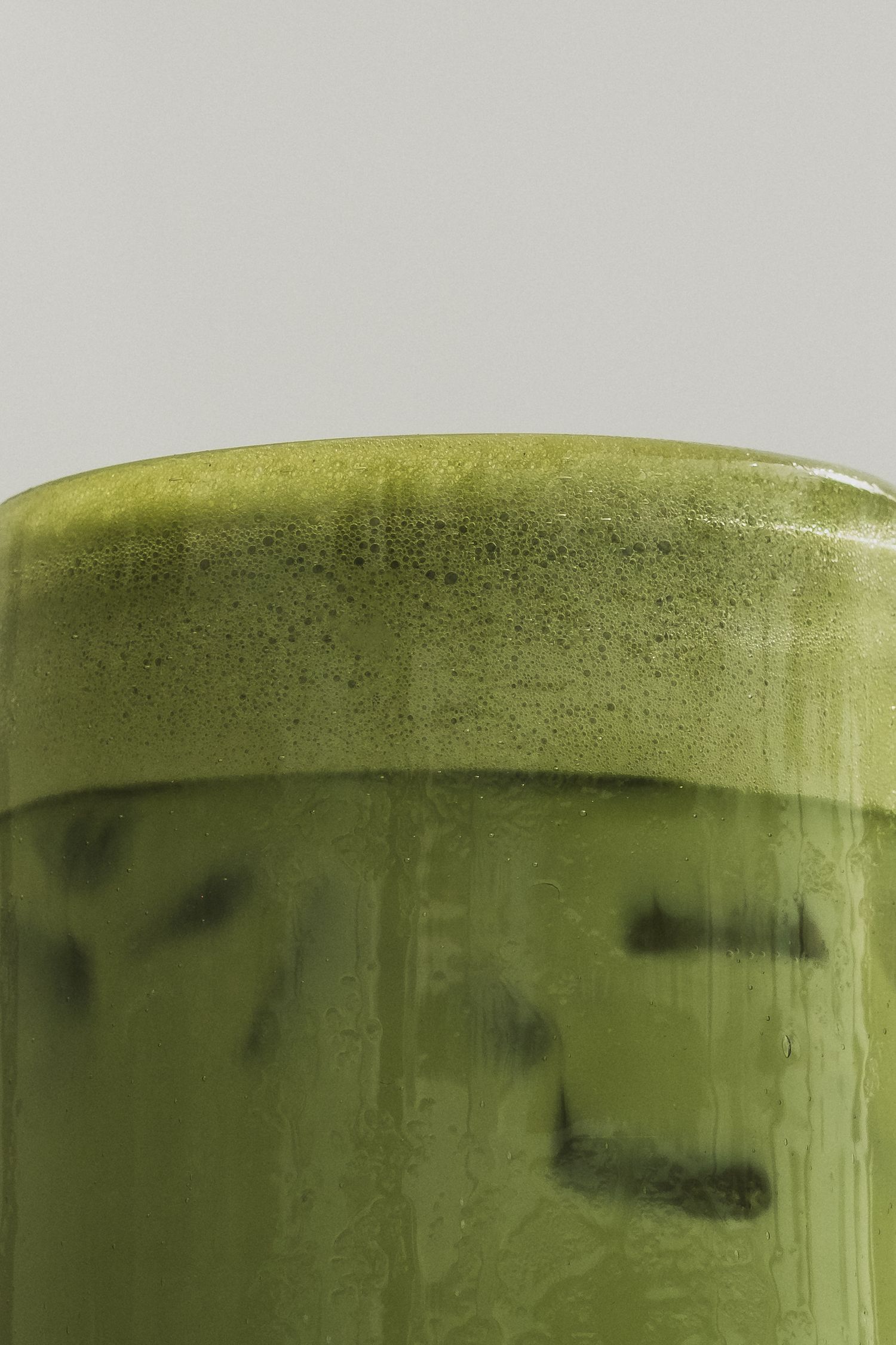 Close-up sequence showing the surface of a green smoothie or juice drink.
