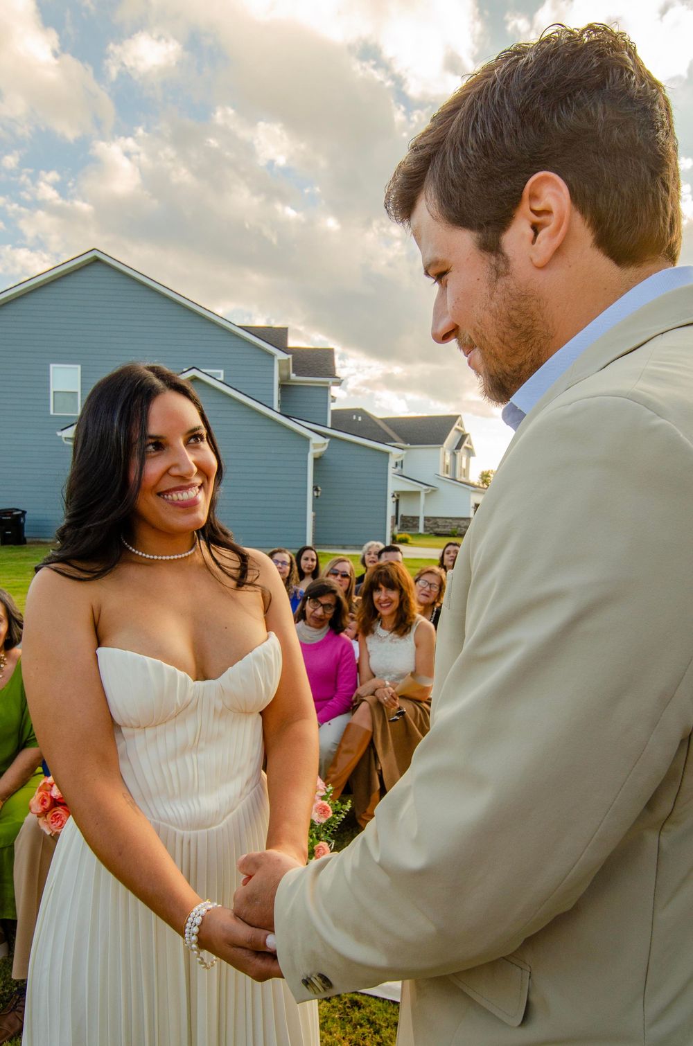 Four sequential photos show a tender moment between a bride in white and groom in beige during an outdoor wedding celebration.