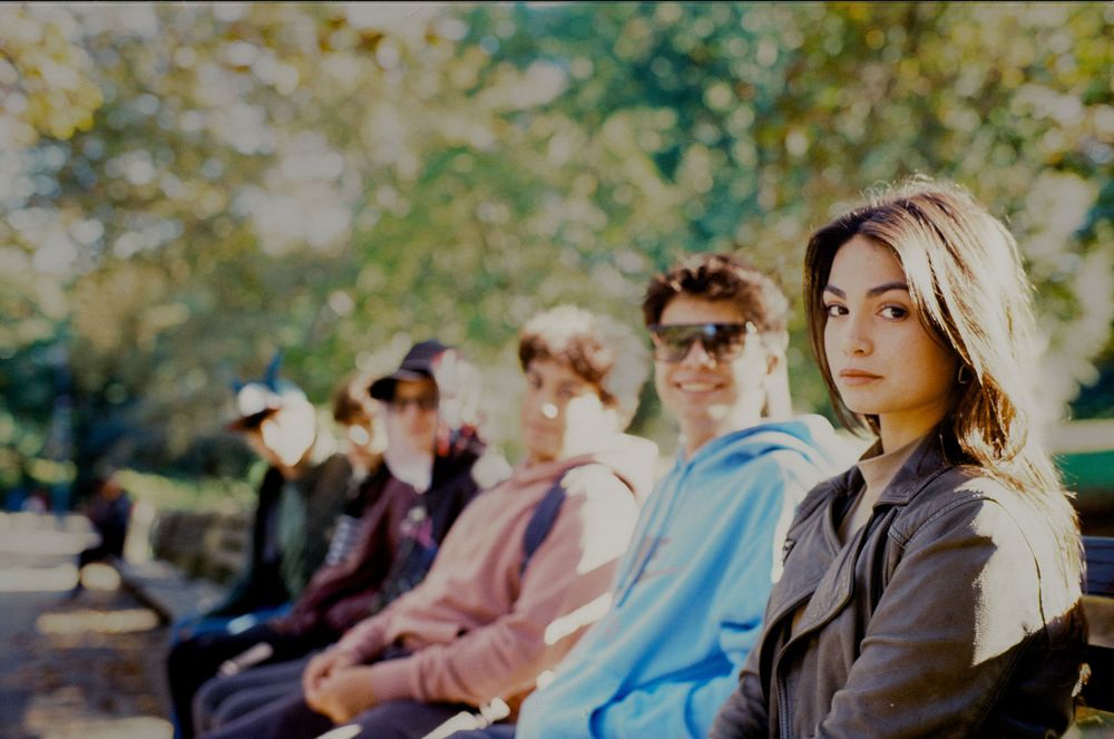 Group of people relaxing outdoors on a sunny autumn day.