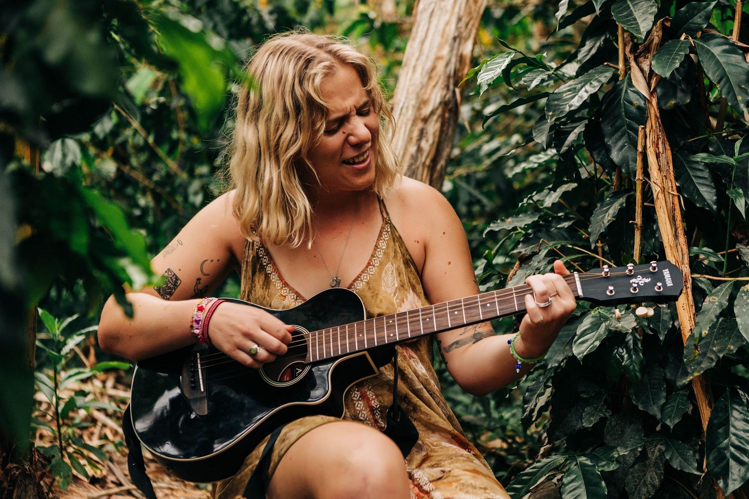 A solo session of a woman in Vilcabamba Ecuador playing her guitar in the woods