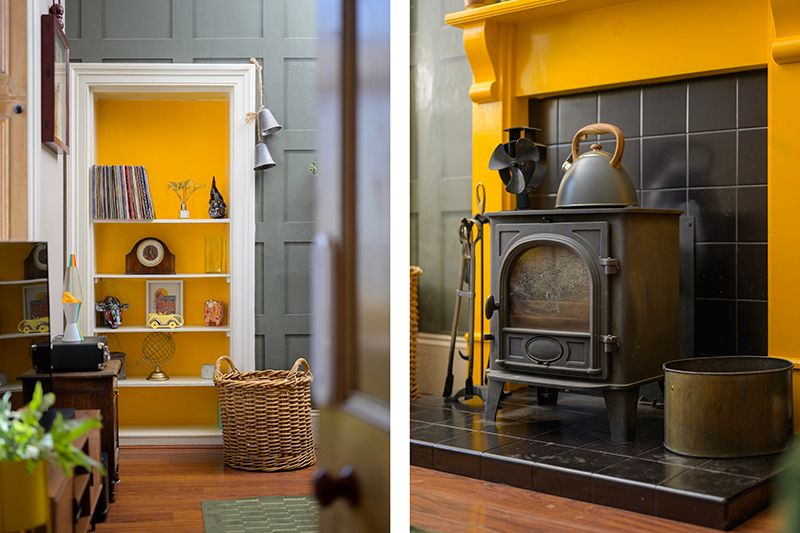 A bright yellow accent wall with black fireplace and white trim creates a modern living room focal point.
