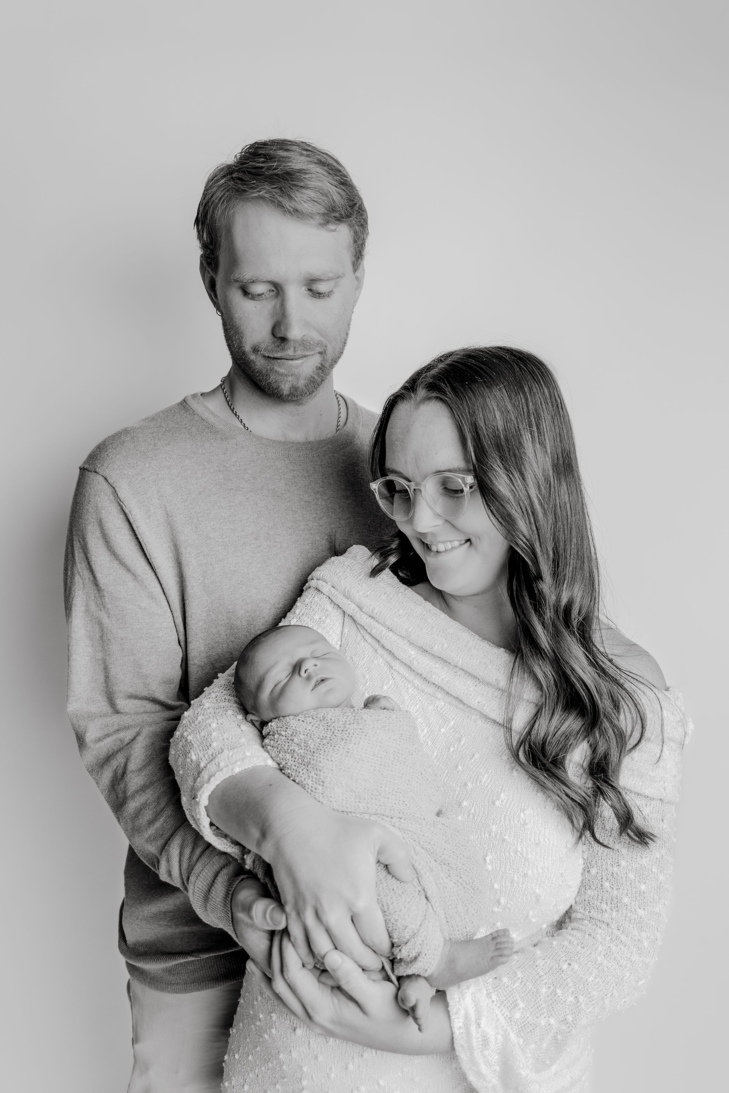 Black and white maternity photos showing tender moments between expectant parents.