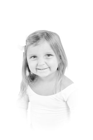 Close up portrait of child in white shirt with gentle expression.