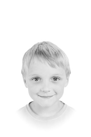 Black and white portrait of child with gentle smile.