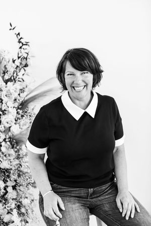 Professional portrait series showing a casual business look with a black top and white collar against a light background.
