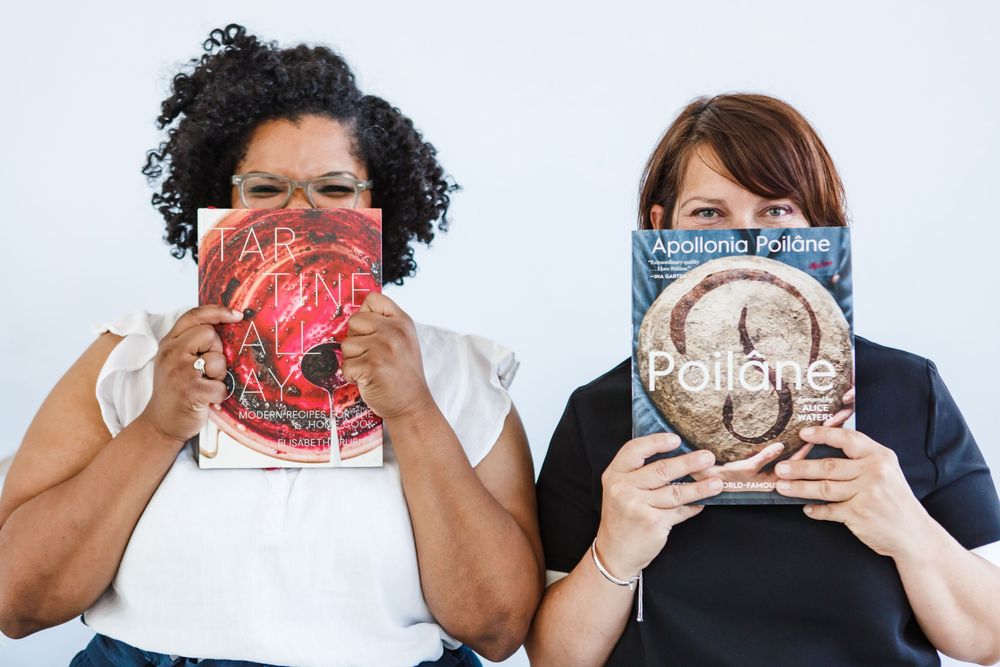Two people playfully hiding their faces behind restaurant menus in a photo series.