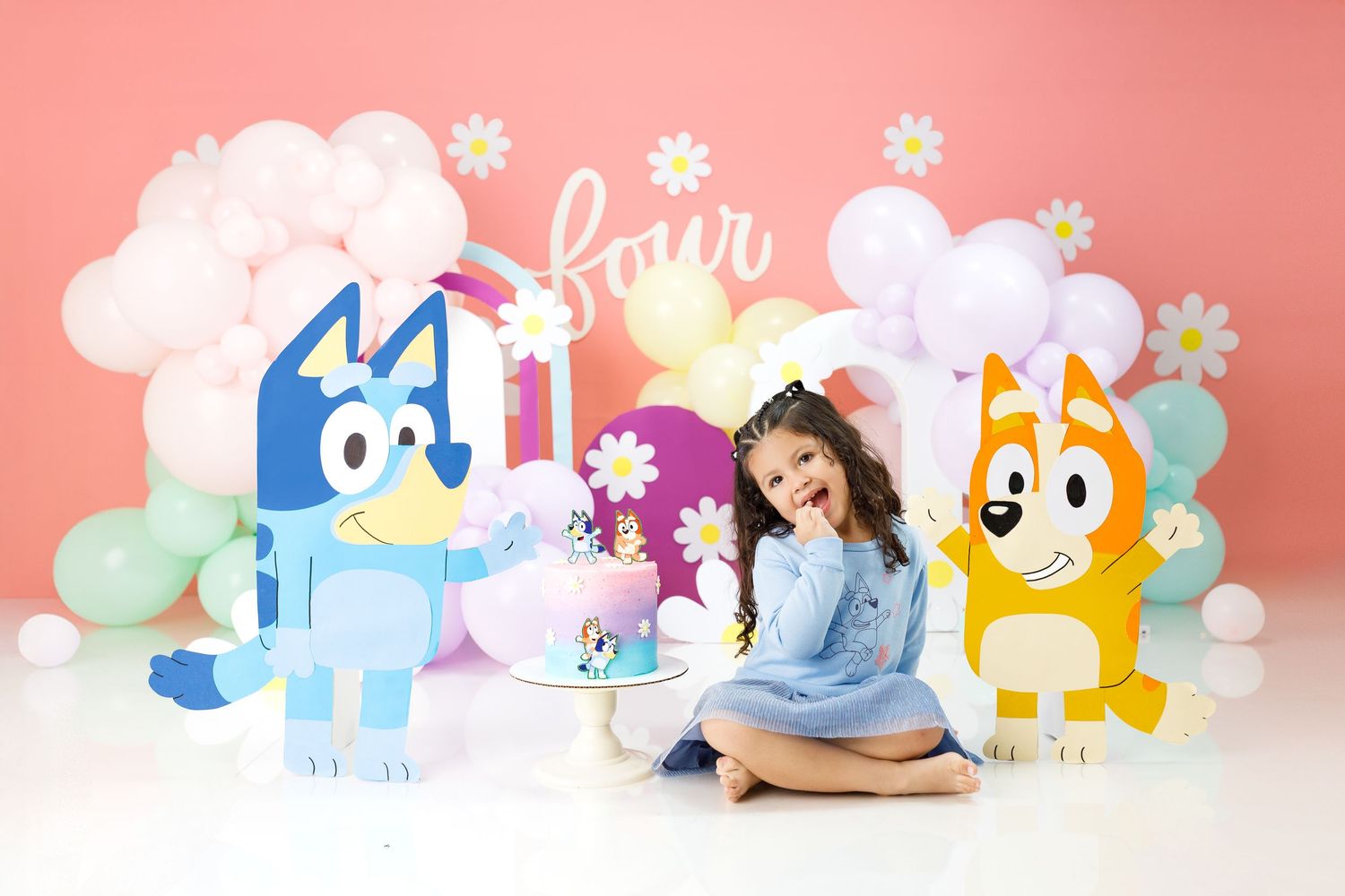Cute plush toys of colorful cartoon ponies arranged in a row against a pink and white gradient background.