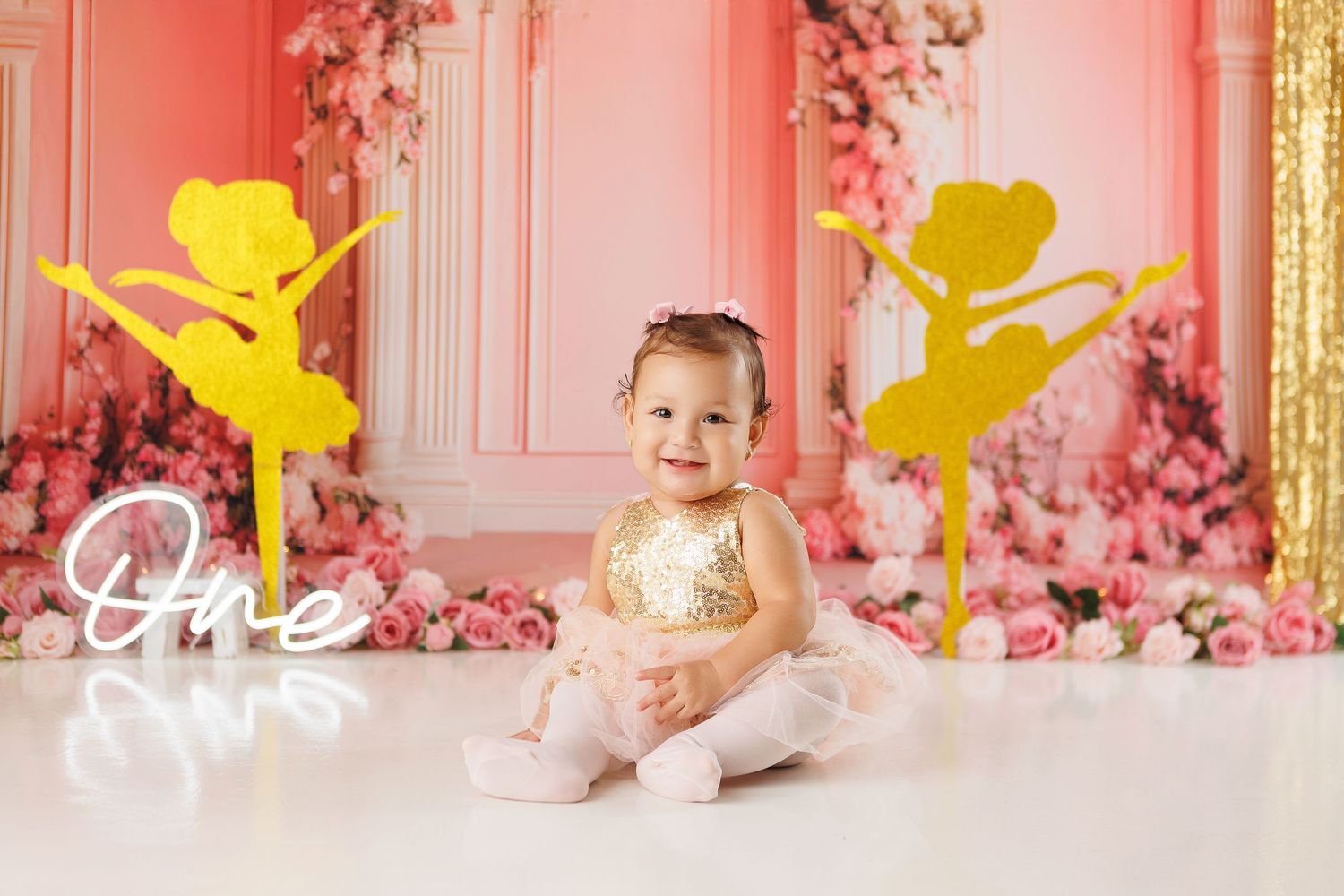 A pink floral backdrop with yellow ballerina silhouettes creates a whimsical dance-themed party setting.