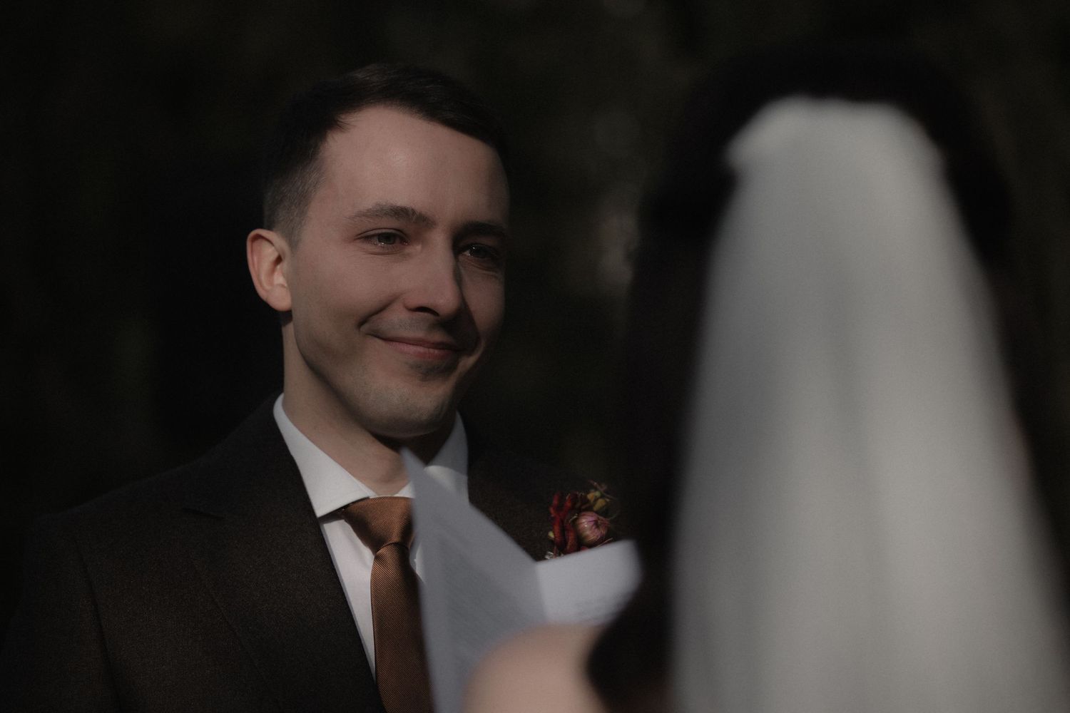 A black and white wedding photo series showing intimate moments between a bride and groom in formal attire.