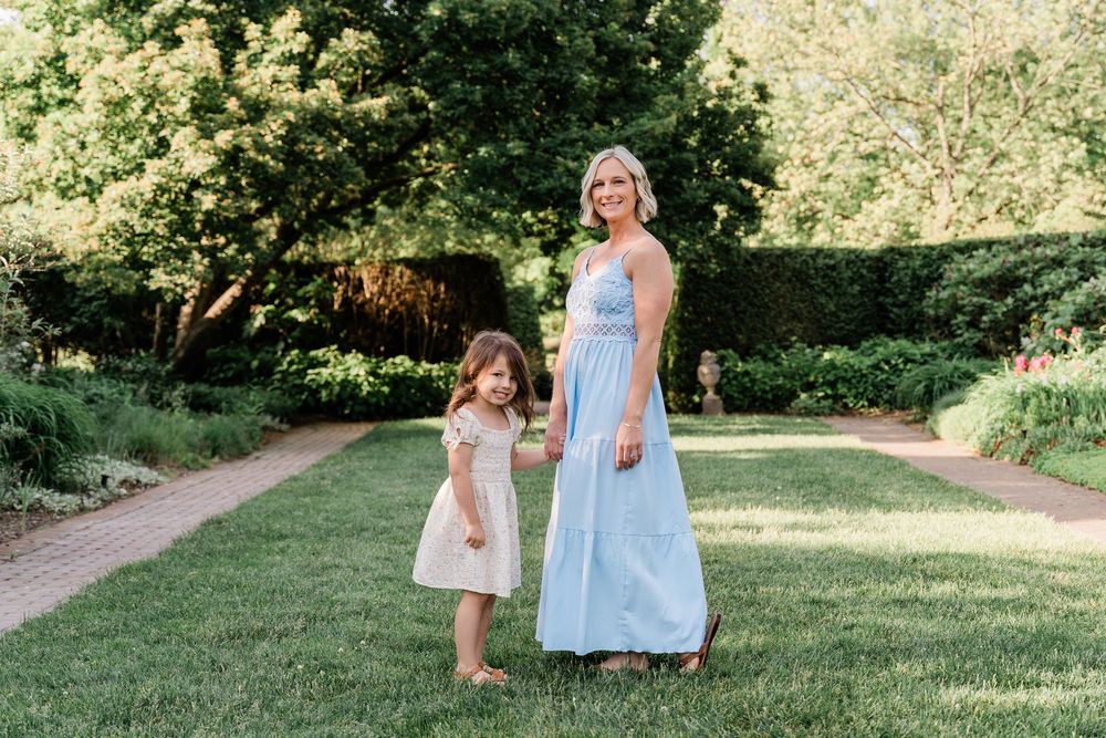 A collection of outdoor photos showing a woman in blue dress and a child enjoying a summer day in a grassy area.