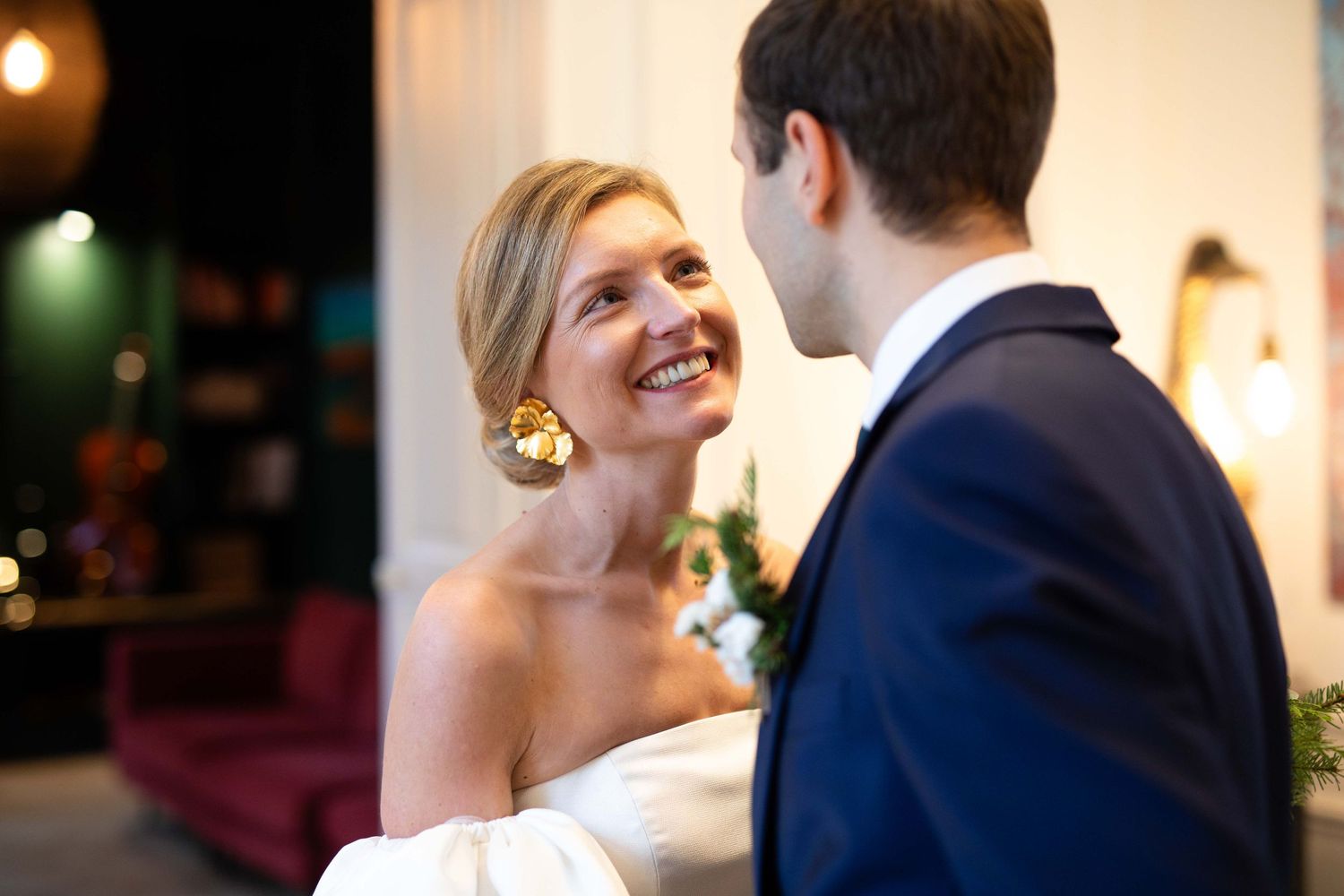 Soft-lit wedding portraits showing tender moments between bride and groom.