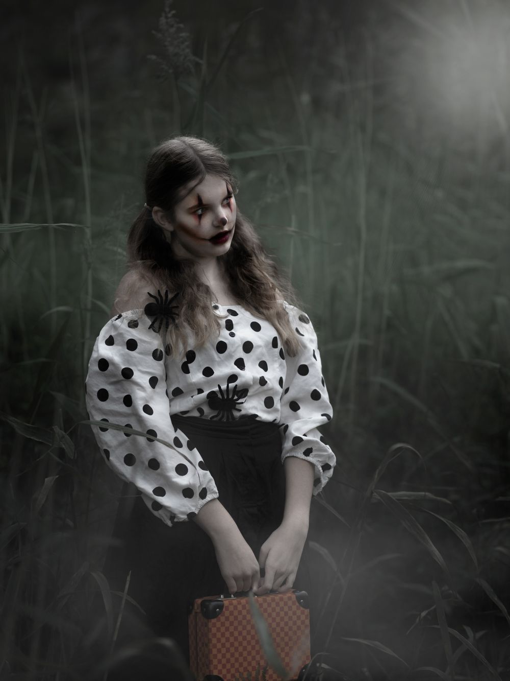 A moody artistic photo series shows a figure in a polka dot dress against a dark forest background.