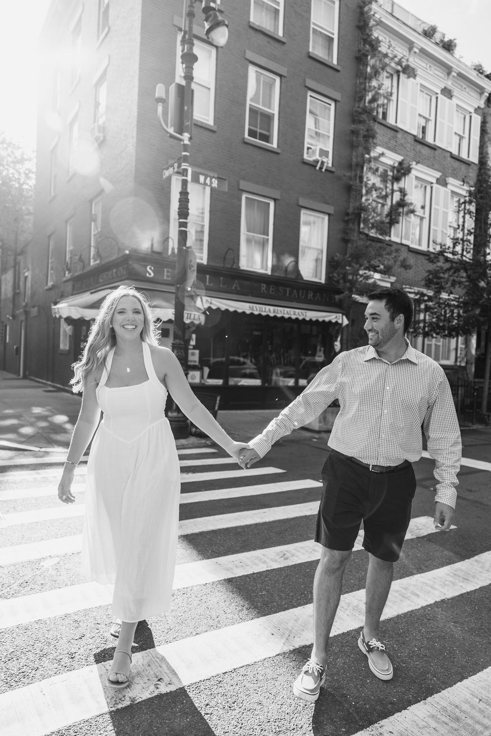 Black and white sequence of people walking across a crosswalk on a sunny urban street.