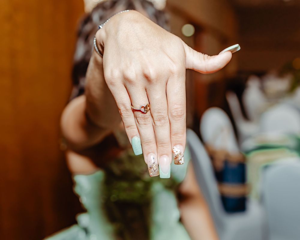 Close-up shot of hands exchanging wedding rings during a traditional ceremony.