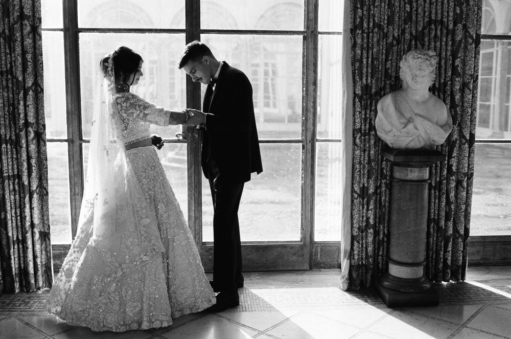 A groom searches for his name in brides henna at Cuneo Mansion.