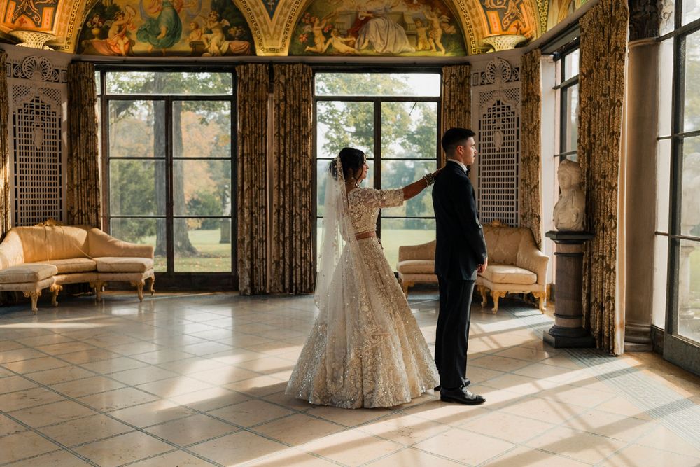 A bride and groom during their first look in the Cuneo Mansion's Formal Dining room.