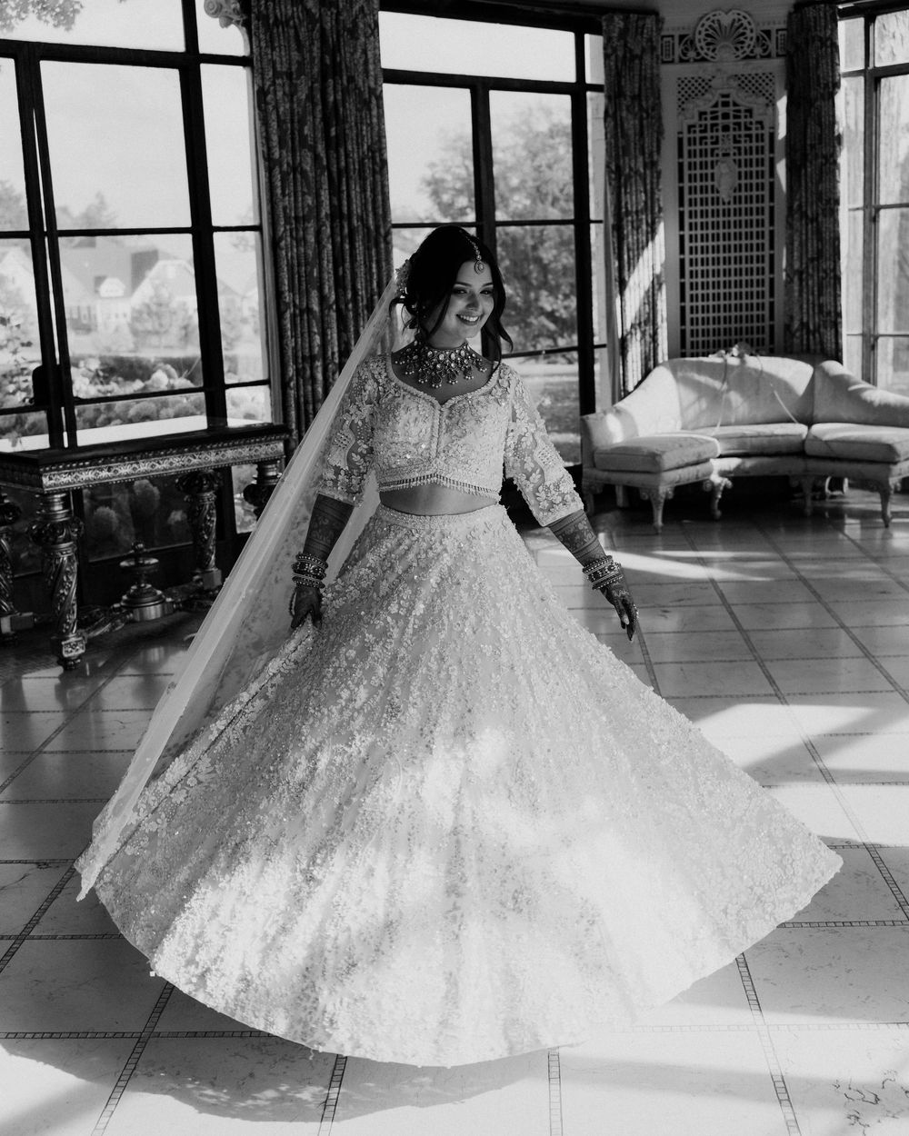 An Indian bride spins in her skirt in Cuneo Mansion's formal dining room.