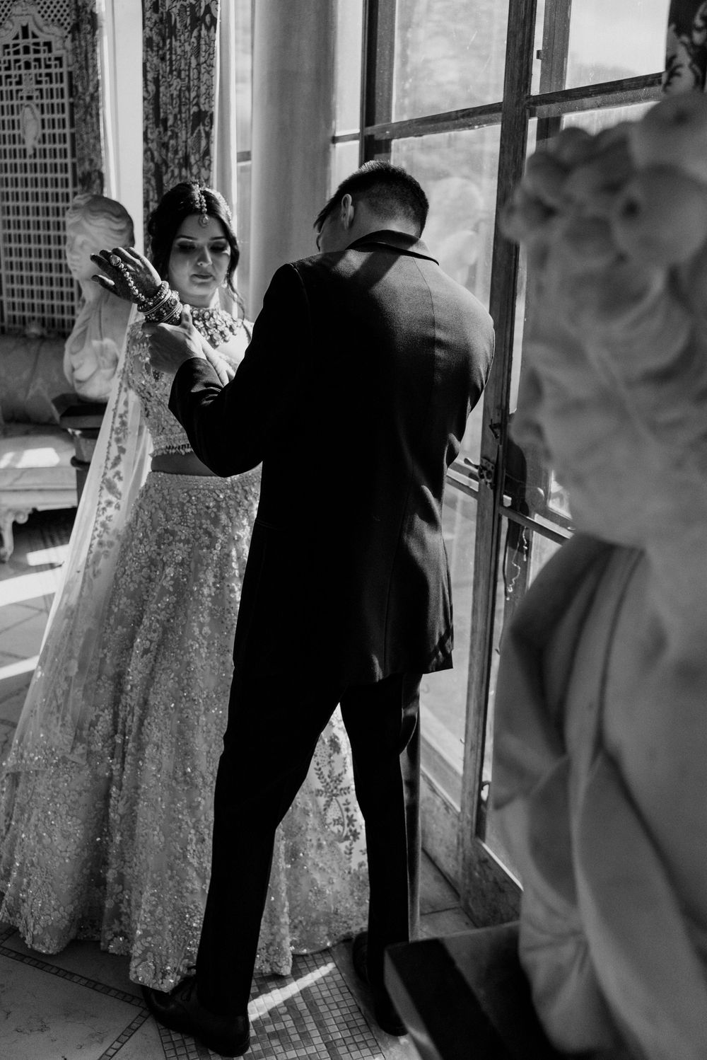 A groom searches for his name in brides henna at Cuneo Mansion.
