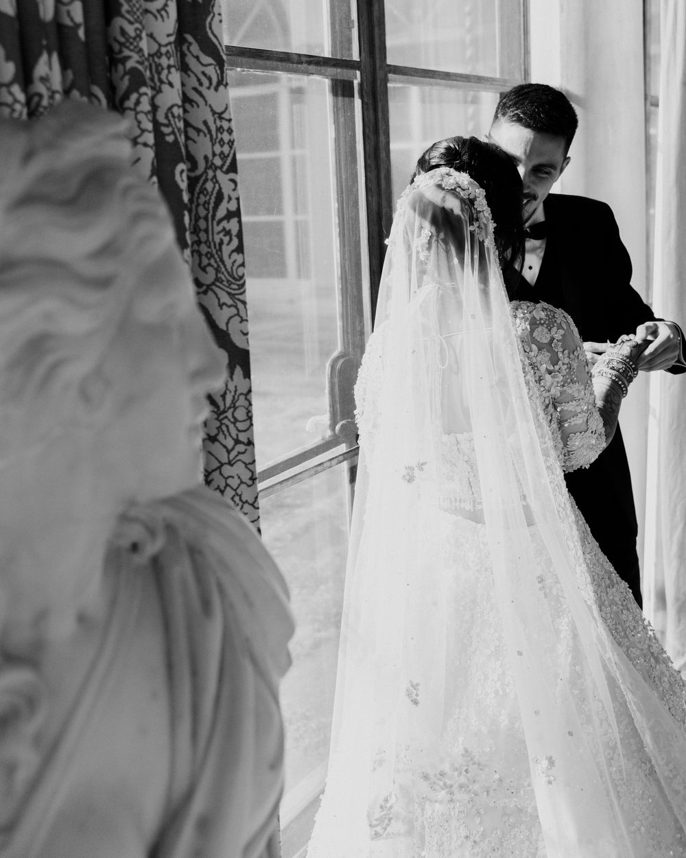 A groom searches for his name in brides henna at Cuneo Mansion.