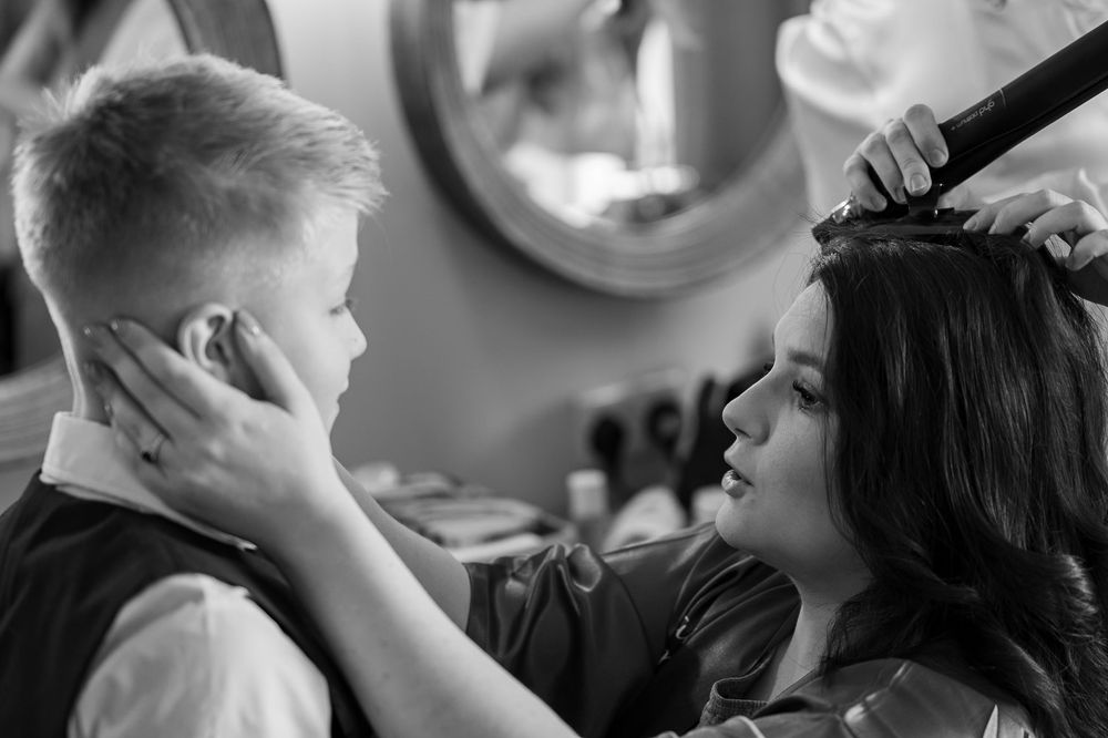 Black and white portrait of a styling session in a salon.