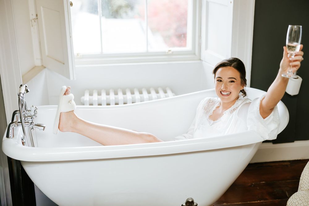 A vintage clawfoot bathtub sits against a white wall in a bright bathroom interior. Farnham estate