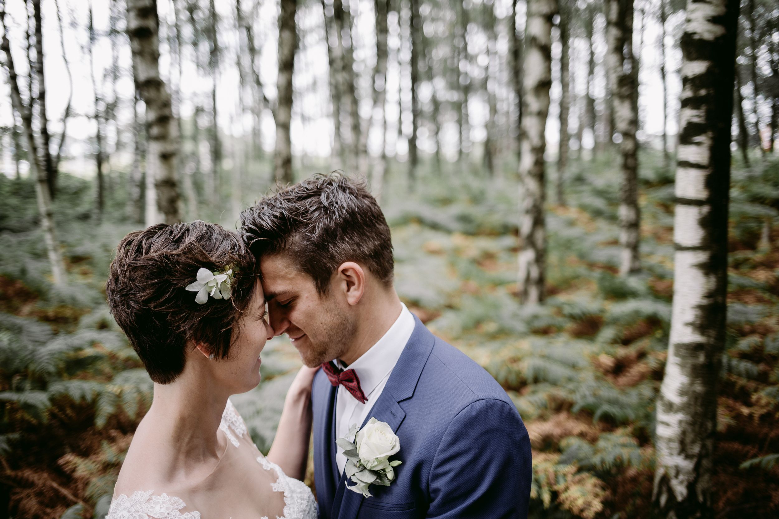 Intimate forest wedding portrait surrounded by birch trees.