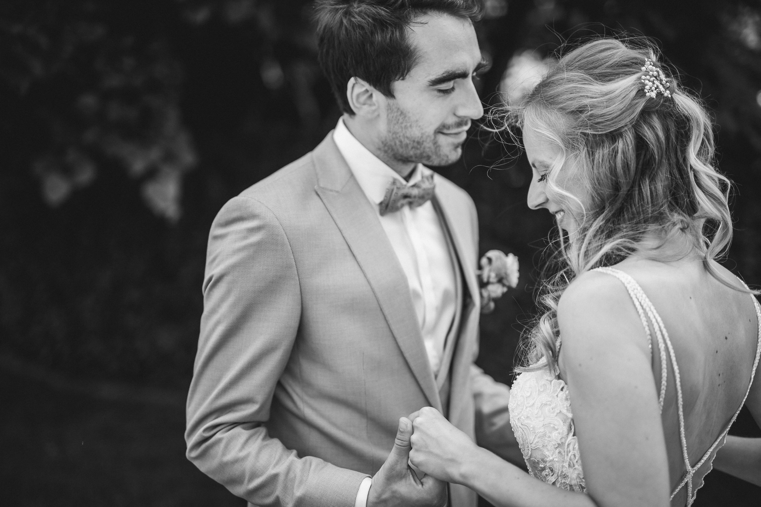 Romantic couple sharing tender moments in a garden setting.
