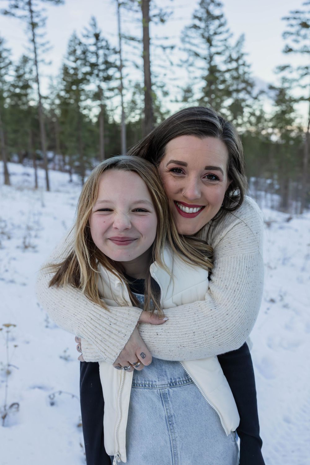 Close-up candid shots in the snow wearing white sweaters and denim.