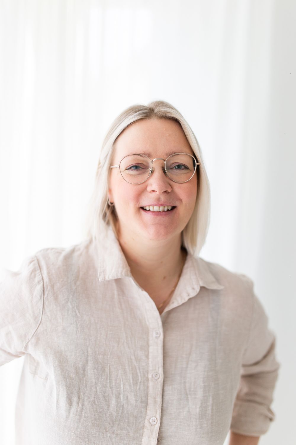 Luonnollinen profiilikuva luonnonvalossa Turussa taustalla vaaleat verhot