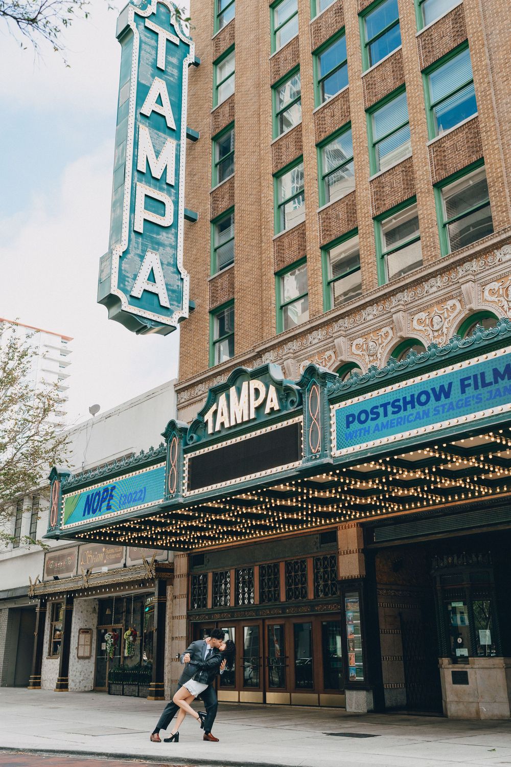 An exterior view of the iconic Tampa Theatre marquee with its classic neon signage.