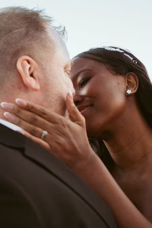 A romantic close-up of a bride and groom sharing an intimate moment during their wedding day.