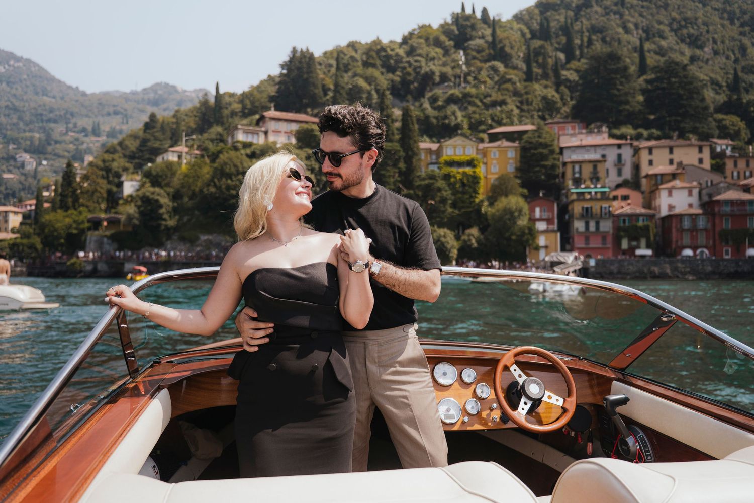 Couple enjoying romantic moments on a sleek white boat.