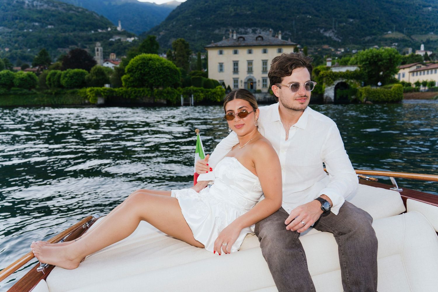 Couple enjoying romantic moments on a sleek white boat.